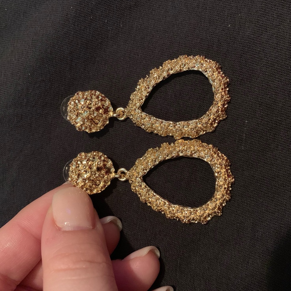 Gold earrings.